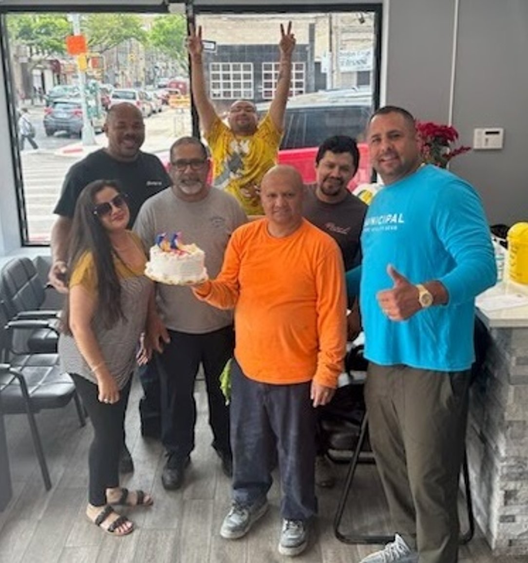 The staff of Grand Auto Repair grouped together